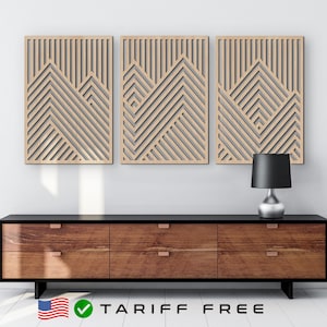 May include: Three wooden wall panels with a geometric pattern of intersecting lines. The panels are arranged in a row on a white wall above a dark brown dresser with four drawers.