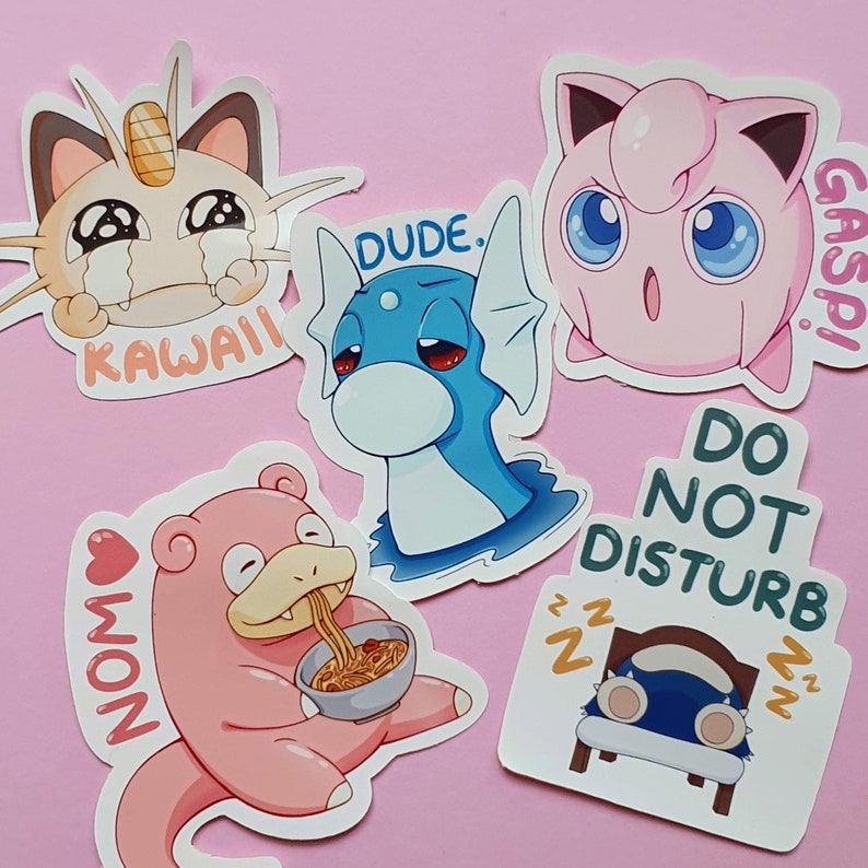 May include: A collection of colorful cartoon stickers featuring various characters. One sticker shows a crying cat with the word "KAWAII". Another depicts a blue dragon-like creature with "DUDE" above it. A pink creature is eating noodles with "NOM" next to it.