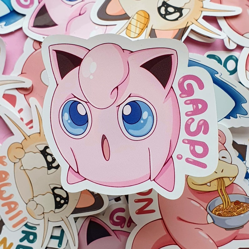 May include: A pink sticker of a cartoon character with large blue eyes and the word "GASP!" in a speech bubble. The character has a surprised expression and is surrounded by other cartoon stickers.