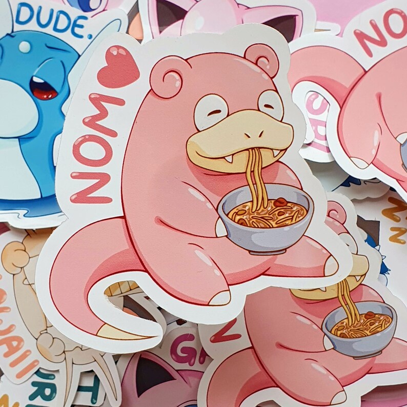May include: A collection of colorful stickers featuring cartoon characters. One sticker shows a pink Slowpoke eating noodles from a bowl, with the word "NOM" and a heart. Other stickers include a blue cartoon character and pink characters.