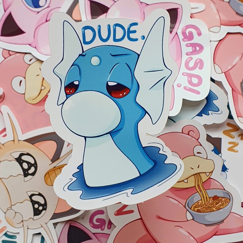 May include: A sticker featuring a blue cartoon character with the word "DUDE." above its head. The character has red eyes and a sad expression. The sticker is surrounded by other colorful cartoon stickers.