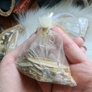 Peace Mojo Bag. Made by Audra of Lifespiritssocietyofmagick.com with real hoodoo spells & magick. Full of herbs and crystals.
