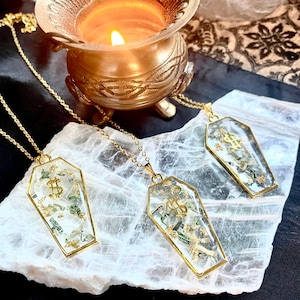 Buried in cash coffin necklace. Real shredded money & gold flakes. Affirm that you want wealth and prosperity. Free custom abundance spell!