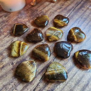 Tigers Eye. Free spell option for your mini heart crystal. Associated with: Luck, Protection, Prosperity, Strength, Kundalini awakening.