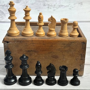 Germany wooden chess set 80s in good condition with original box .  A great gift for collectors and chess lovers.