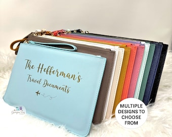 May include: A collection of rectangular zippered travel document pouches in various colors including light blue, brown, white, yellow, orange, pink, teal, and black. The light blue pouch features the text The Hefferman's Travel Documents.