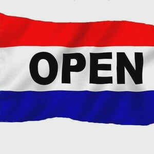 May include: A red, white, and blue flag with the word "OPEN" in bold black letters. The flag is divided into three horizontal stripes: red on top, white in the middle, and blue on the bottom. The flag is attached to a silver pole.
