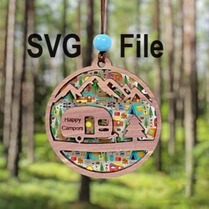 Puede incluir: Un adorno de madera con forma de autocaravana con una escena de montaña y el texto "Happy Campers" en la parte delantera. El adorno está decorado con un patrón colorido de iconos con temática de camping.