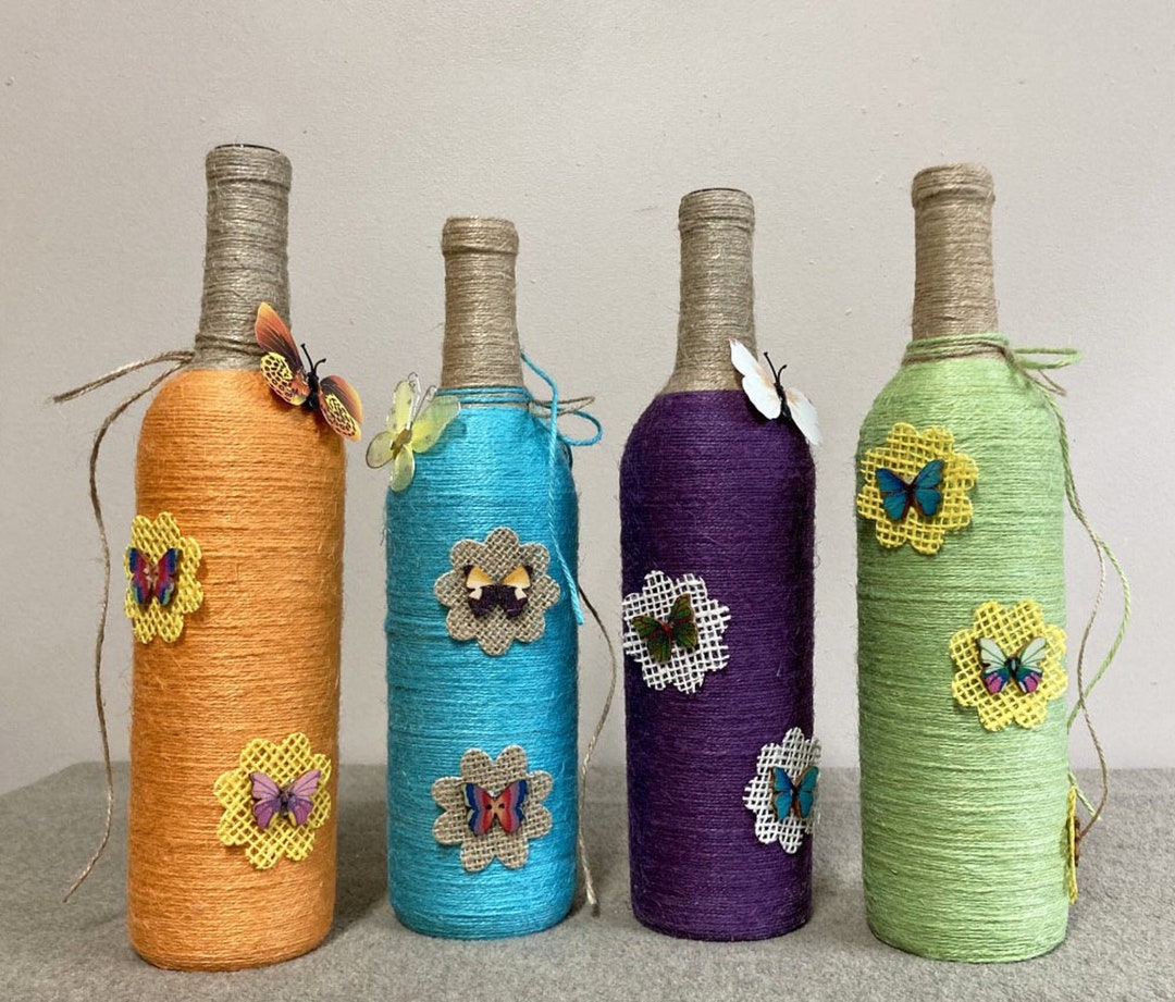 Jute Wrapped and Decorated Wine Bottle Decor. Each Bottle Has a