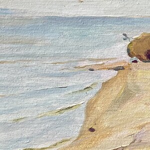 Puede incluir: Una pintura de un paisaje mar&iacute;timo con una playa de arena y un acantilado rocoso en el fondo. El agua es de color azul claro y la arena es de color marr&oacute;n claro. El cielo es de color gris claro.