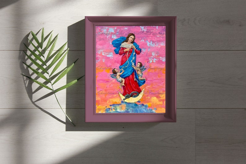 May include: A framed painting of a woman in a blue and red dress standing on a crescent moon with two angels. The background is a pink and orange abstract design.
