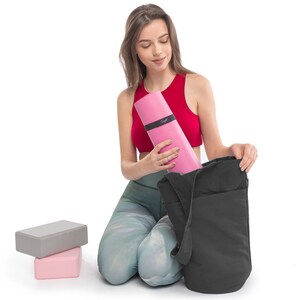 girl putting away yoga accessories in the yoga bag