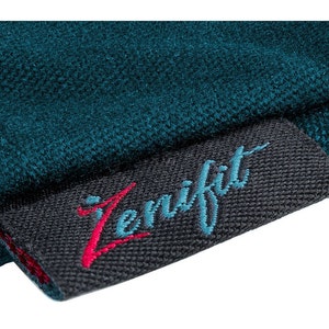 May include: A teal blue fabric with a black label that says "Zenifit" in a teal blue and red embroidered font.