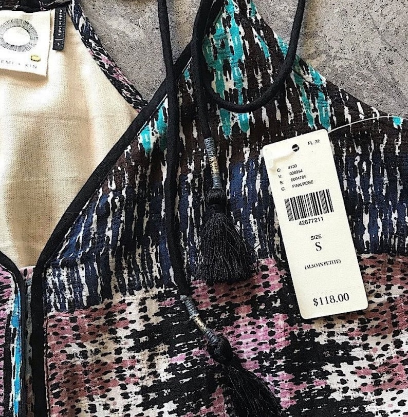 May include: A black and blue patterned sleeveless top with a black trim and tassel ties. The tag reads "Size S (Also in Petite)" and "$118.00".