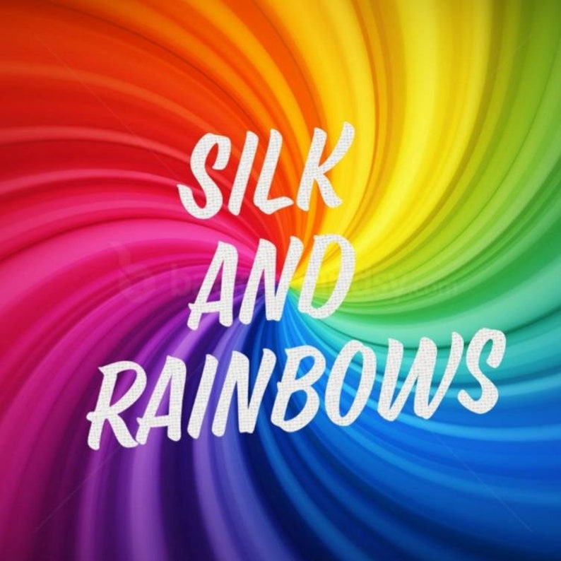 May include: A colorful rainbow swirl background with the text "SILK AND RAINBOWS" in white.