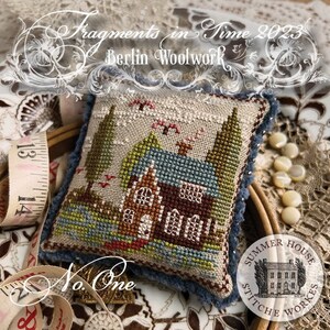 May include: A cross stitch pattern featuring a small house with a blue roof and green trees. The pattern is titled "No. One" and is part of the "Fragments in Time 2023" collection by Berlin Woolwork.