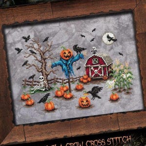 May include: Cross-stitch design featuring a Halloween scene with a scarecrow, pumpkins, crows, and a red barn. The design includes a full moon, a skeleton, and a cornfield. The text at the bottom reads "HALLOW O' CROW CROSS STITCH".