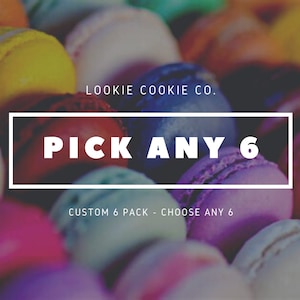 May include: A close-up of colorful macarons with the text "LOOKIE COOKIE CO. PICK ANY 6 CUSTOM 6 PACK - CHOOSE ANY 6" in white text on a white rectangle.