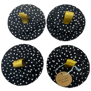 May include: Set of four black and white polka dot fabric hair scrunchies with gold ribbon loops. The scrunchies are handmade and have a tag that says "Handmade with love".