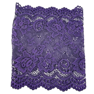 May include: Purple lace trim with a scalloped edge. The lace has a floral pattern.