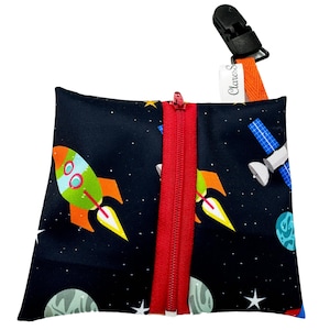 May include: A black zippered pouch with a red zipper. The pouch has a space-themed print with rockets, planets, stars, and a satellite. The pouch has a black clip with the text "Cleaness" on it.