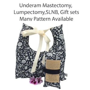 May include: Two black and white floral print pillows with a white satin ribbon. The smaller pillow has a brown tag with the text "Hand Heat Comfort Pillows by Dawn's Sew Cozy".