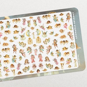 May include: A sheet of nail art decals featuring a variety of cherub designs. The decals are white with colorful cherubs in various poses, including flying, holding hands, and playing musical instruments. The sheet is labeled "Cherubs Symphony" and "Nail Art Decals".