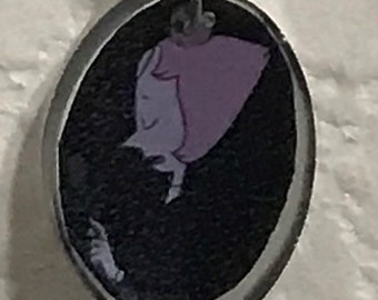 May include: A black cord necklace with a round pendant featuring a cartoon character with pink hair and a black background.