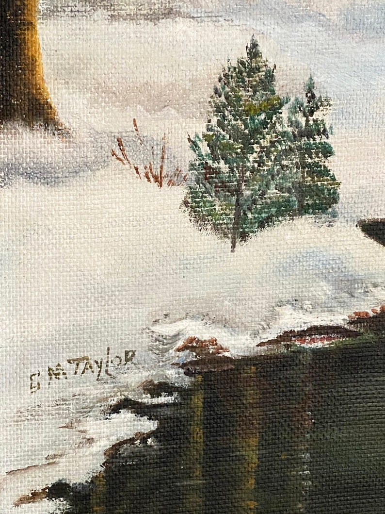 May include: A winter landscape painting with a snowy scene and a small evergreen tree in the foreground. The painting is signed "G.M. Taylor" in the lower left corner.