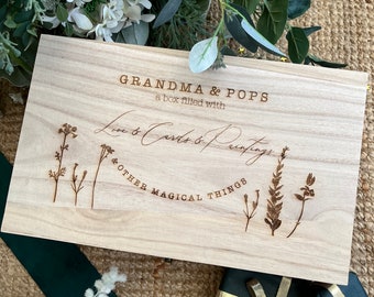 May include: A wooden box with the text "Grandma & Pops a box filled with Love & Cards & Drawings & Other Magical Things" engraved on the lid. The box is decorated with a floral design.