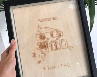 Retrato de una casa dibujado a mano con marco de madera