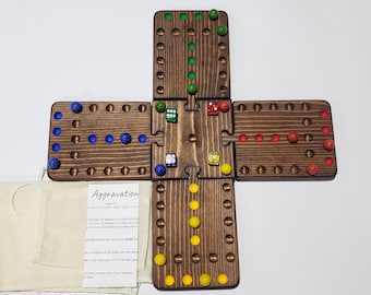 May include: A wooden game board with four sections, each with a row of holes and marbles. The game is called "Aggravation" and the instructions are printed on a small piece of fabric.