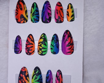 May include: A set of 10 false nails with a rainbow splatter paint design. The nails are displayed on a white card with the text "MAKE A SPLASH".