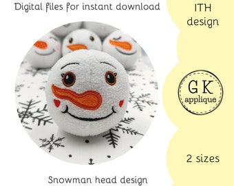 May include: Embroidered snowman head design in two sizes. The design features a white snowman head with black eyes, a red mouth, and an orange nose. The design is perfect for creating a cute and festive snowman ornament or plush toy.