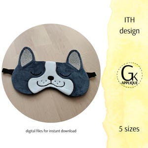 May include: A navy blue sleep mask shaped like a dog's face with closed eyes. The mask has a white muzzle and ears with textured gray fabric. The mask includes a black elastic strap. The text "ITH design" and "5 sizes" are visible.