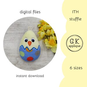 May include: A yellow chick peeking out of a blue and white egg with colorful polka dots. The chick has a red beak and black eyes. The image is on a wooden background with a bouquet of yellow daffodils. The text "ITH stuffie" and "GK applique" are also visible in the image.