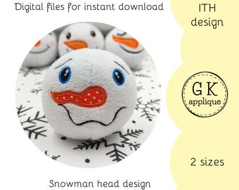 May include: A white snowman head applique design with blue eyes, an orange nose, and a red mouth. The design is available in two sizes. The image includes the text "ITH design" and "GK applique".