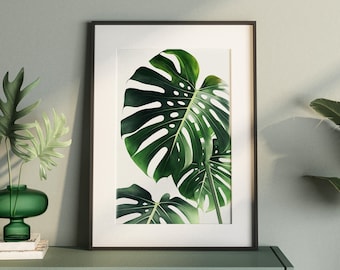 Könnte beinhalten: Ein gerahmter Kunstdruck mit grünen Monstera-Blättern mit charakteristischen Löchern. Das Kunstwerk wird auf einem hellgrünen Schrank präsentiert, ergänzt durch eine Topfpflanze und dekorative Vasen, die eine natürliche, moderne Ästhetik schaffen.