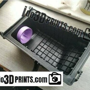 May include: A black plastic air filter housing with a purple air filter inside. The housing has a grid pattern and is designed to fit a car.