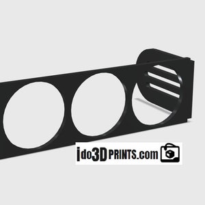 May include: Black plastic gauge pod with three round openings for gauges. The pod has a rectangular shape with a curved edge on one side. The text "ido3DPRINTS.com" is printed on the bottom of the pod.