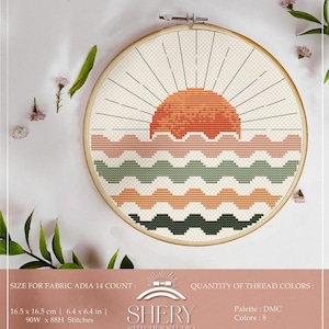May include: A cross-stitch embroidery hoop featuring a sunset design. The sun is a vibrant orange, with radiating lines against a cream-colored background. Below the sun are wavy patterns in shades of pink, green, and orange. The hoop is 6.4 x 6.4 inches.