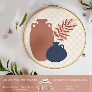 May include: A cross-stitch design featuring a terracotta vase, a navy blue vase, and a reddish-brown leaf. The design is set in a wooden embroidery hoop. The text "SHERY STICHES STUDIO" is visible. The fabric size is 7.86 x 7.21 inches.