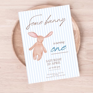 May include: A light blue and white striped invitation card with the text "Some bunny is turning one." A watercolor illustration of a bunny is featured. The card includes the date, time, and RSVP information.