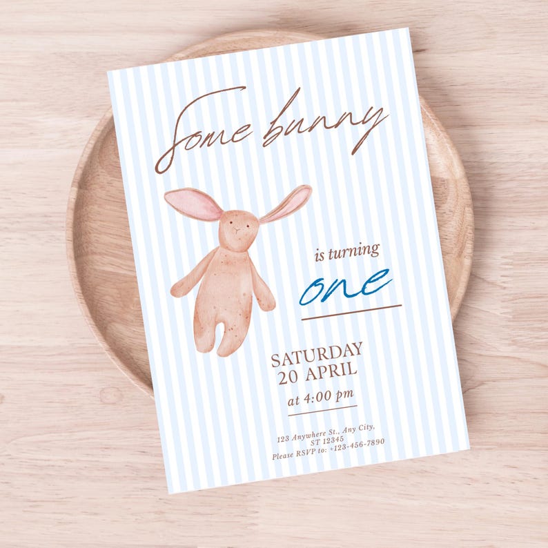 May include: A light blue and white striped invitation card with the text "Some bunny is turning one." A watercolor illustration of a bunny is featured. The card includes the date, time, and RSVP information.