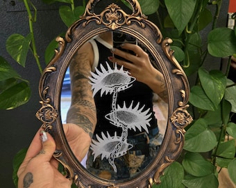 Hand-etched eyes of the witch mirror