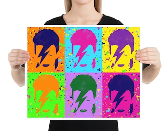 Puede incluir: Una impresión de estilo pop art con seis imágenes de David Bowie con un rayo en la cara. Cada imagen es de un color diferente, incluyendo naranja, rosa, azul, verde, morado y amarillo. El fondo es un lienzo blanco con salpicaduras de pintura de colores.