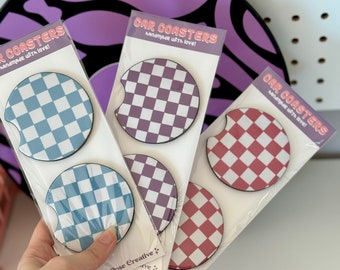 May include: Set of six car coasters with checkered patterns in blue, purple, and red. The coasters are handmade with love and packaged in clear plastic.