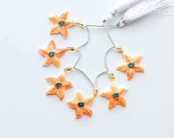 Conjunto de 6 pingentes em forma de concha de estrela-do-mar laranja natural com incrustações de topázio azul, banhados a ouro e com fecho de pino | 25x25x5 a 24x25x5 mm