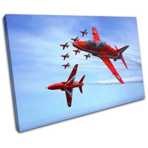 May include: A canvas print featuring a formation of red and white jet aircraft against a blue sky. The jets are leaving white contrails. The image captures the dynamic movement of the aircraft in flight.