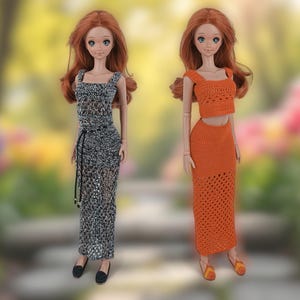 May include: Two dolls with red hair and blue eyes are shown. One doll wears a black and white crocheted dress with a black belt. The other doll is dressed in an orange crocheted crop top and skirt. Both dolls are wearing shoes.